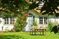 Beautiful and romantical entrance and garden of an old german farmhouse with framework and blooming plants Royalty Free Stock Photo