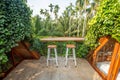 Beautiful rooftop bedroom with table and chair outside terrace with trees