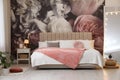 Room interior with large bed, mirror and floral pattern on wall Royalty Free Stock Photo