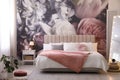 Room interior with large bed, mirror and floral pattern on wall Royalty Free Stock Photo