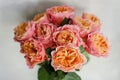 Beautiful roses flowers in a vase on a table . Bouquet of pink and orange multicolor flower. Decoration of home Royalty Free Stock Photo