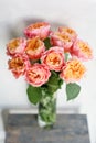 Beautiful roses flowers in a vase on a table . Bouquet of pink and orange multicolor flower. Decoration of home Royalty Free Stock Photo