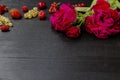 Beautiful roses with leaves and berry on the dark wood background. Great conposition with roses and berry, copy space