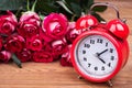 Beautiful roses and red alarm clock Royalty Free Stock Photo