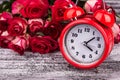 Beautiful roses and red alarm clock Royalty Free Stock Photo