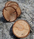 Beautiful round slide of wood, cherry wood pieces placed on sand