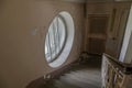 A beautiful round window in an old abandoned hospital. Ancient staircase. The interior of an abandoned building. Royalty Free Stock Photo