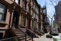 Row of Colorful Old Brownstone Homes on the Upper East Side of New York City along a Street and Sidewalk Royalty Free Stock Photo