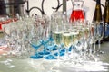 Beautiful row line of different glasses filled with champagne are lined up ready to be served on a christmas party, martini, vodka Royalty Free Stock Photo