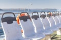 A beautiful row of plastic white chairs on the ferry on the sea Royalty Free Stock Photo