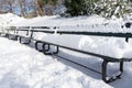 Beautiful Snow Covered Row of Benches at Central Park in New York City during the Winter Royalty Free Stock Photo