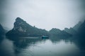 A fisherman in his boat in Ha Long Bay Vietnam Royalty Free Stock Photo