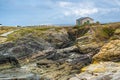 Beautiful rugged view of the coast of Galicia with the sea entering the rocks with moss and lichen and a rural road that leads to