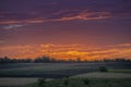 beautiful rural landscape. corn field and grass, Idyllic rural pretty farmland pink orange clouds sun during sunset sunrise, Royalty Free Stock Photo