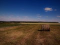 View of  summer field, hay bales, row of forest and sky Royalty Free Stock Photo