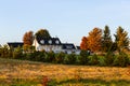 Beautiful rural landscape with French style patrimonial house and barns seen during a late afternoon golden hour