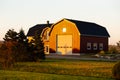 Beautiful rural landscape with large red barn seen during a late afternoon golden hour