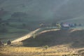 Beautiful rural mountain landscape in the morning light with fog,old houses and haystacks Royalty Free Stock Photo