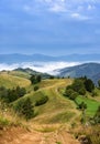 Beautiful rural mountain landscape with road and fog in the valley. Royalty Free Stock Photo