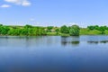 Beautiful rural panorama of a hilly area with a house on the other side of pond Uhroidy/Ugroedy village, Sumy region, Ukraine. Royalty Free Stock Photo