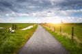 Beautiful rural road, colorful green grass Royalty Free Stock Photo