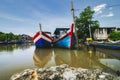 Fisherman boat moored near wooden jetty