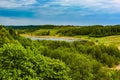 Beautiful rural summer landscape with forest, river, blue sky and white clouds Royalty Free Stock Photo