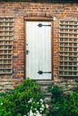 Beautiful rural white rustic door with overgrown by weeds stairs, british countryside house in the middle of nowhere Royalty Free Stock Photo