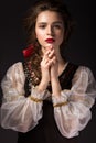 Beautiful Russian girl in national dress with a braid hairstyle and red lips. Beauty face. Royalty Free Stock Photo