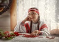Beautiful Russian girl smiles sitting at the table