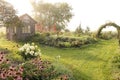 A beautiful Rustic Shed and Vine Covered Arbor in Cottage Garden Royalty Free Stock Photo