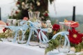 Beautiful rustic theme outdoor wedding or romantic dinner, white altar setup, wedding sand ceremony vases pouring glass lined up Royalty Free Stock Photo