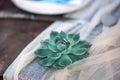 Beautiful rustic wedding style flower with wedding golden rings on a white cloth on wooden table.