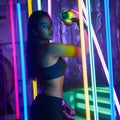 Beautiful 20s Asian Woman punch, poses with Silver gold Mitts Gloves. Office Girl exercise between Modern multi color Fashion Neon