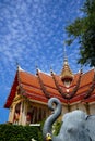 Beautiful sacred red roof and golden spire main hall of famous buddhist temple with blue sky and white cloud background Royalty Free Stock Photo