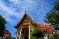 Beautiful sacred red roof and golden spire ornament main hall of famous buddhist temple landscape with blue sky and white cloud Royalty Free Stock Photo