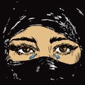 The beautiful sad brown eyed Muslim girl crying , face hidden in a black headscarf hijab