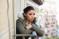 Beautiful sad desperate hispanic woman in winter coat suffering depression Royalty Free Stock Photo