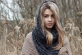 Beautiful sad girl is walking in the field. Photo in brown tones.