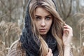 beautiful sad girl is walking in the field. Photo in brown tones. Royalty Free Stock Photo