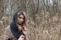 Beautiful sad girl is walking in the field. Photo in brown tones. Royalty Free Stock Photo