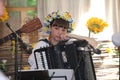 Beautiful sad, pensive girl in the national Ukrainian costume with accordion. Royalty Free Stock Photo