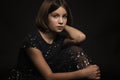 Beautiful sad teen girl, black background Royalty Free Stock Photo