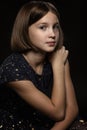 Beautiful sad teen girl, black background Royalty Free Stock Photo