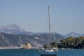 Beautiful sailing boat anchored in the Gulf of poets with the Torre Scuola in the background, Portovenere, Liguria, Italy