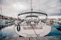 Beautiful sailing yacht on the quay in the port on a cloudy day, view from the stern. High quality photo Royalty Free Stock Photo