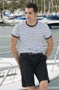 Beautiful sailorman wearing sailor clothes in a ya Royalty Free Stock Photo