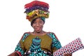 Beautiful saleswoman woman holding traditional loincloths on her head smiling Royalty Free Stock Photo