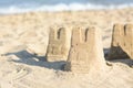 Beautiful sand castles on beach near sea, space for text Royalty Free Stock Photo