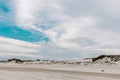 Sand Dunes with Green Grass and a Blue Sky Royalty Free Stock Photo